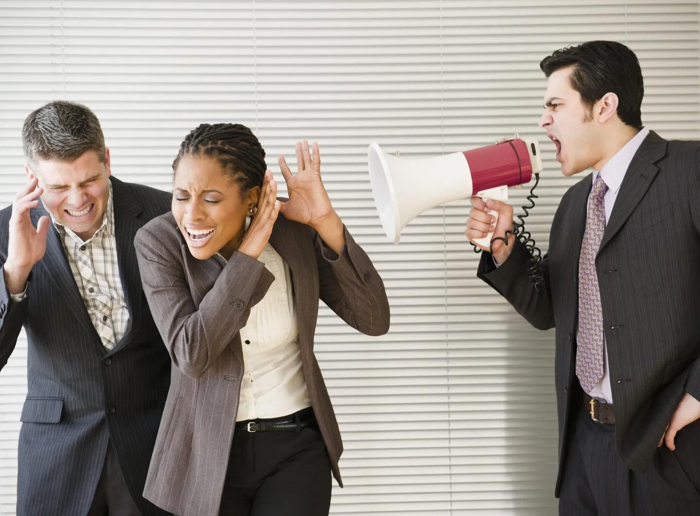 A boss shouts at him employees using a bullhorn to denote an abusive manager.